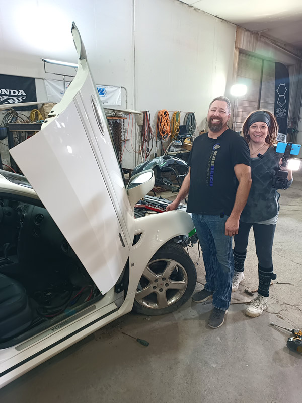 Modern Redneck Engineering team beside custom Pontiac Grand Prix GXP with vertical doors