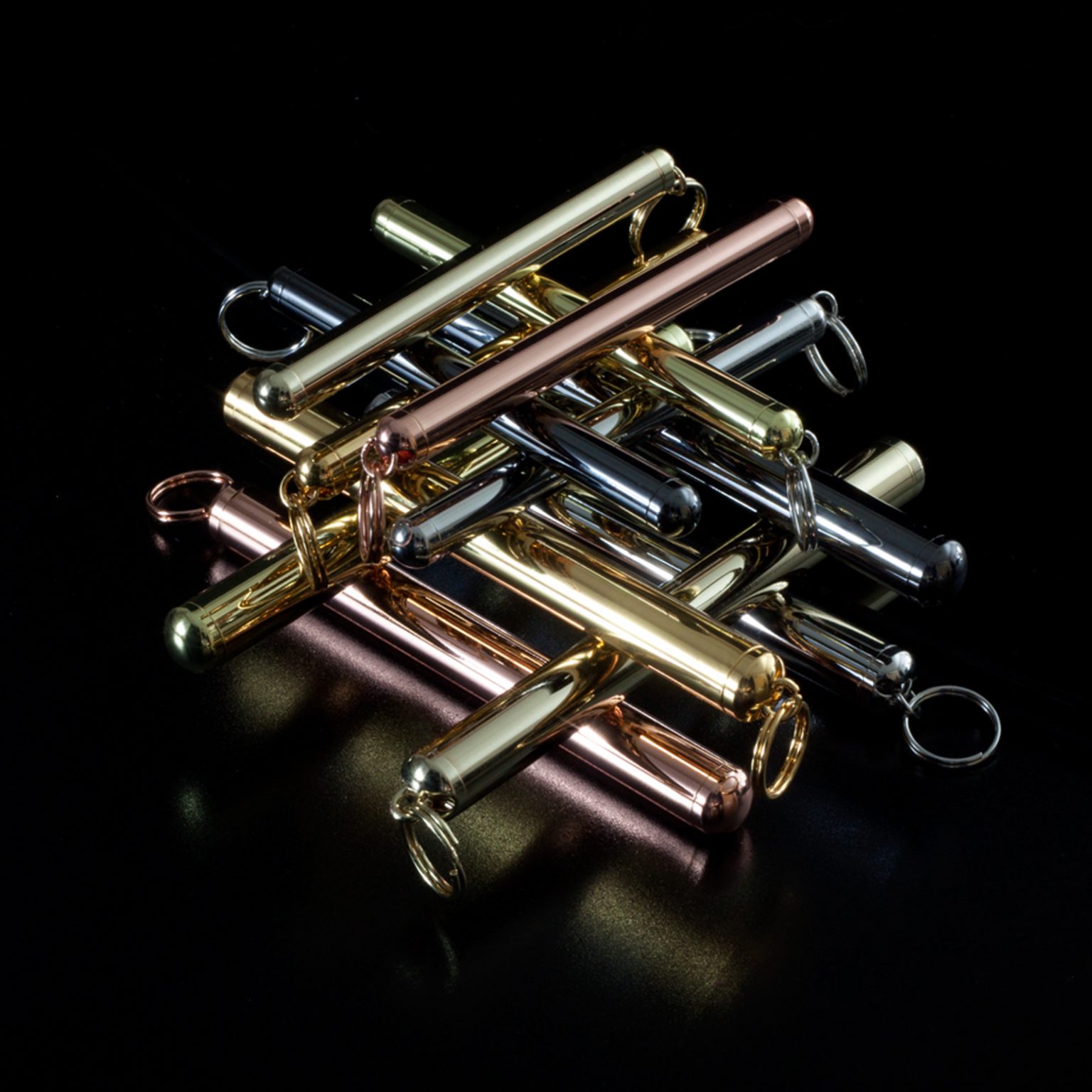 PURC metal vials in multiple finishes stacked together